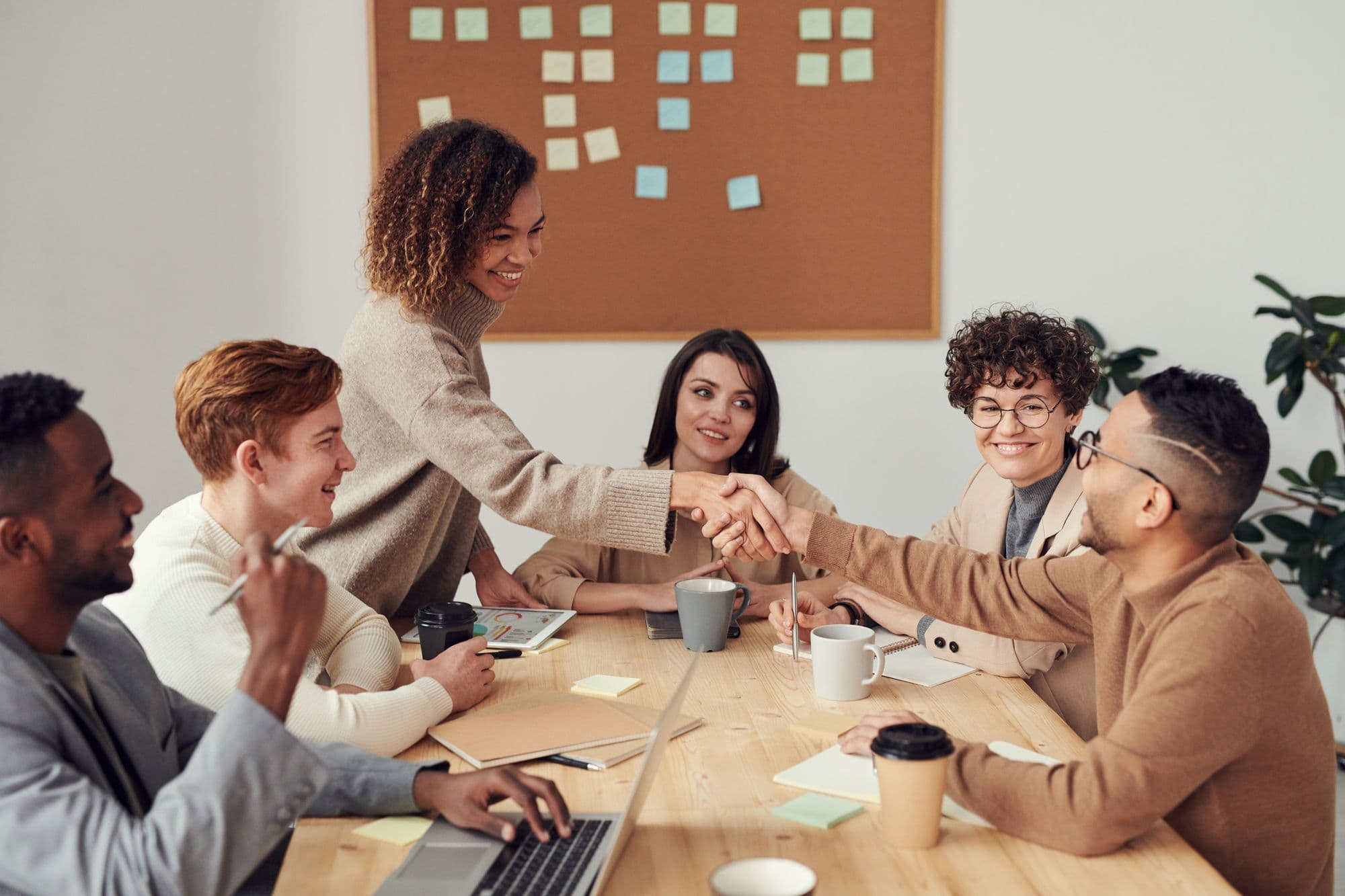 Colleagues sharing ideas around a table in a bright studio