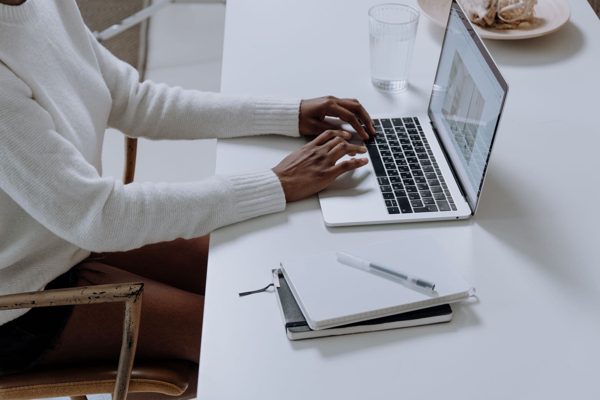 A person working on a laptop at a café table