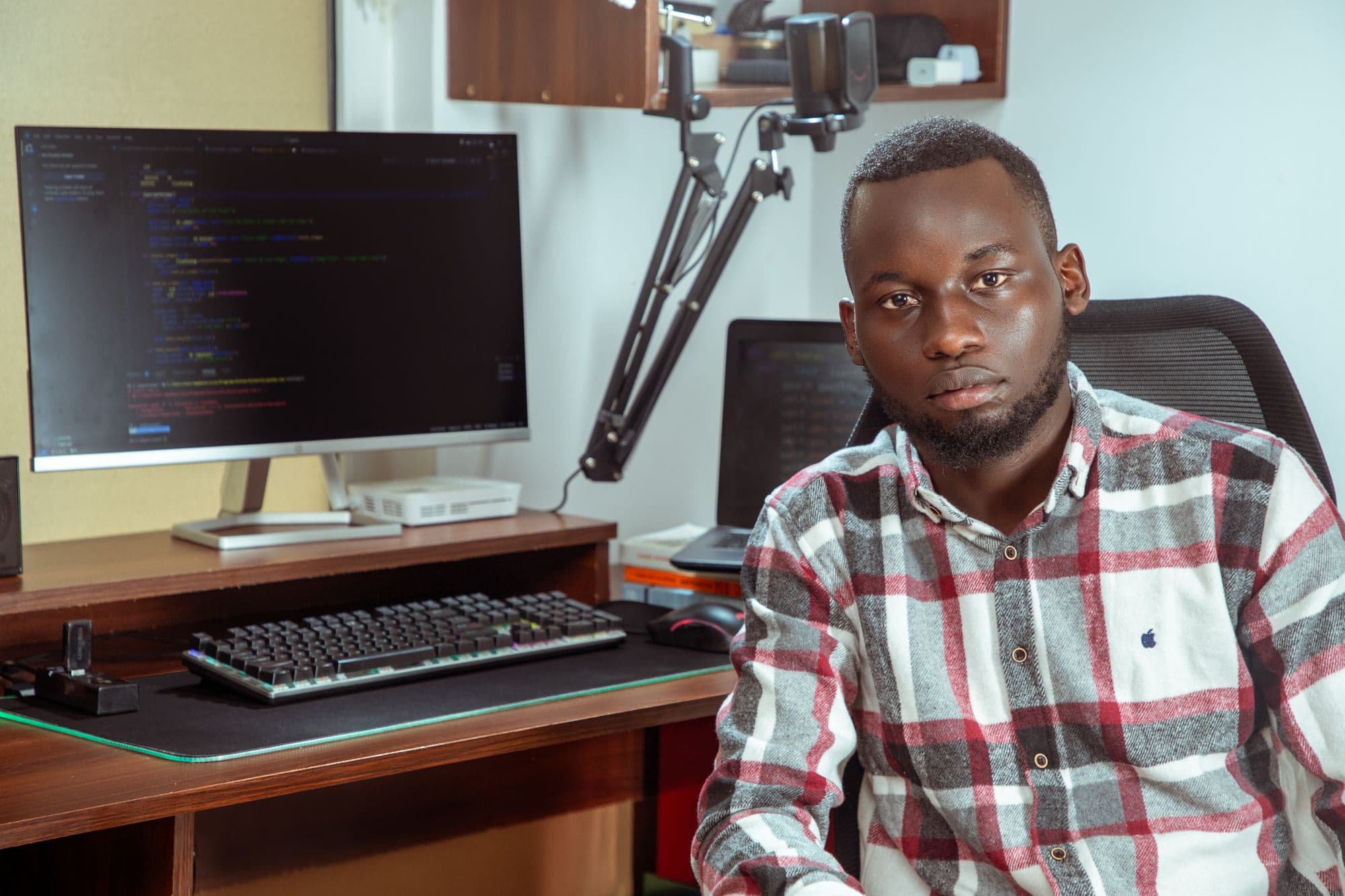 A developer seated at his computer in an office